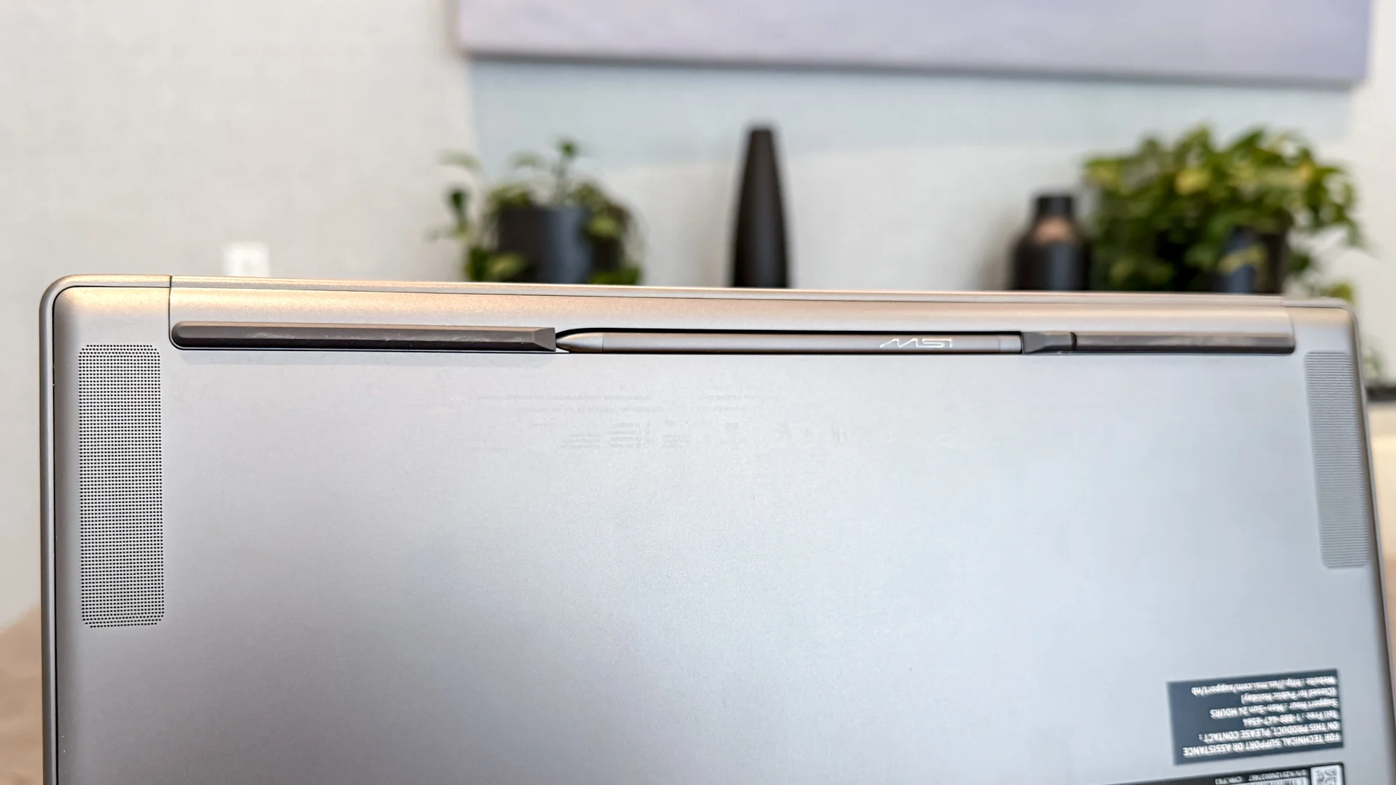 MSI Prestige 14 Flip AI+ stylus in its holder under the laptop